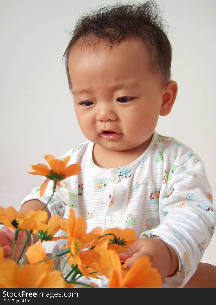 A cute baby and flower. A cute baby and flower