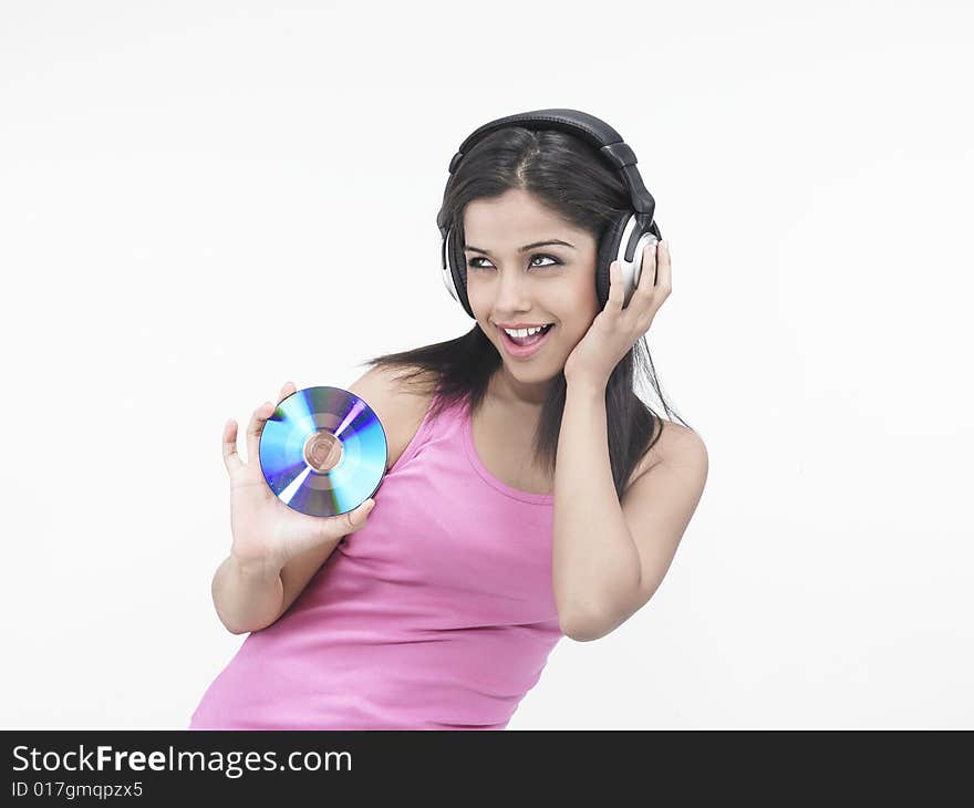 Asian woman with headphones and compact disc