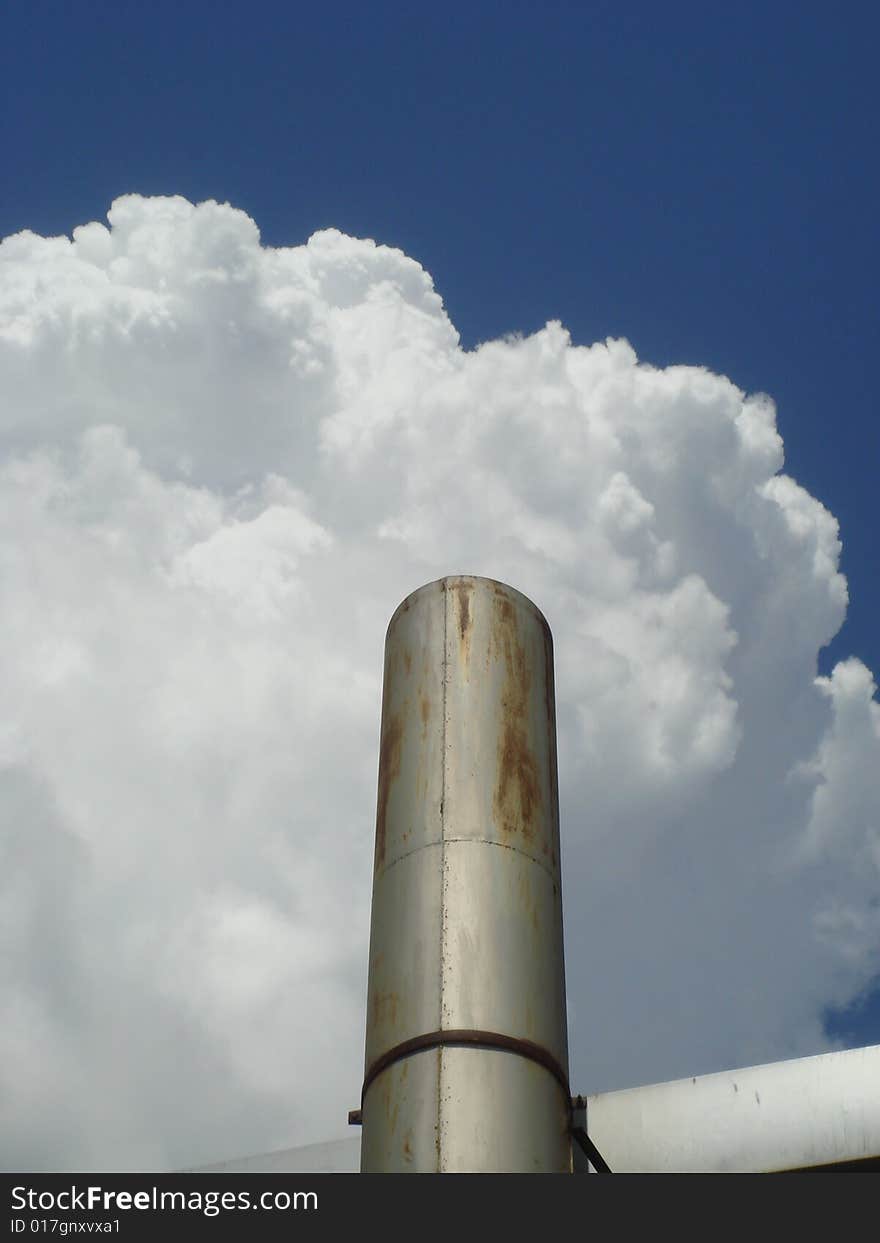 A large factory smoke pipe causing damage to the local environment