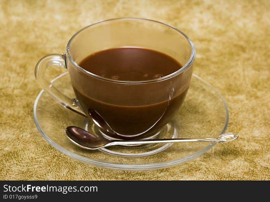 Cup with coffee over brown background