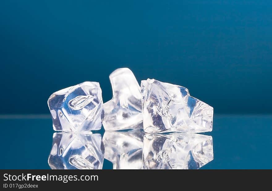 Close-up of ice cubes on blue