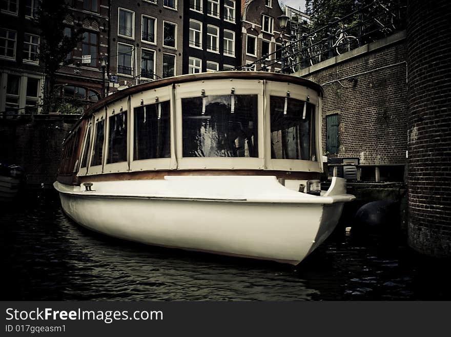 Boat floating in canal in Amsterdam, Holland. Boat floating in canal in Amsterdam, Holland