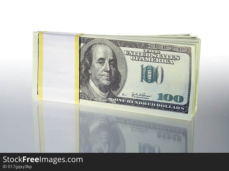 Bundle of dollar's bank notes standing on gray background. Bundle of dollar's bank notes standing on gray background