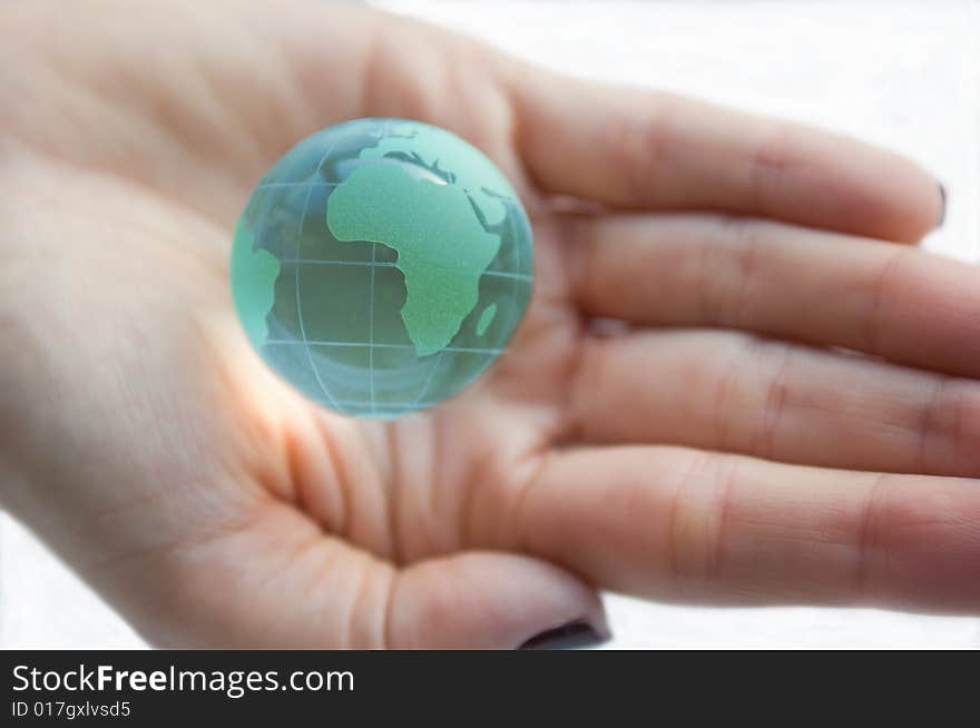 Earth globe (Africa view) in female hands.