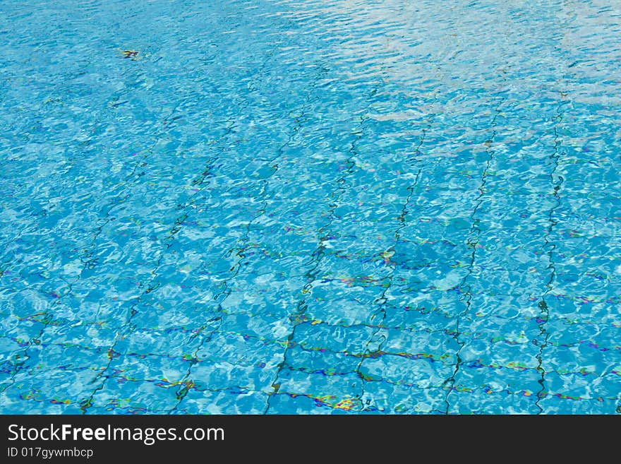 Blue crystal clear swimming pool surface