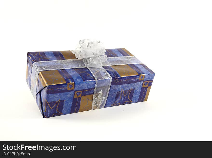 Christmas present in blue paper with silver tie