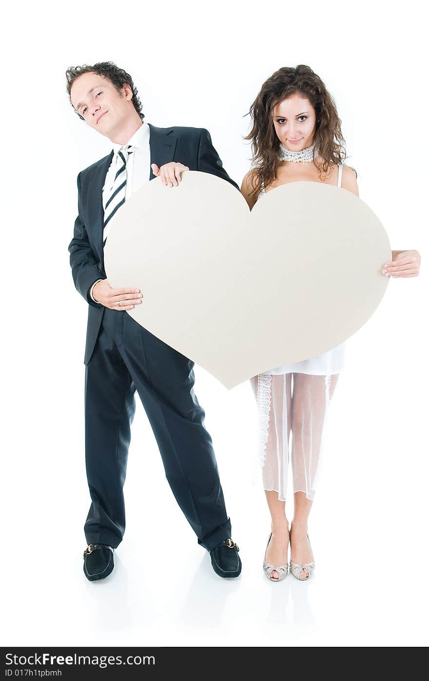 Young couple holding heart shape, isolated on white background