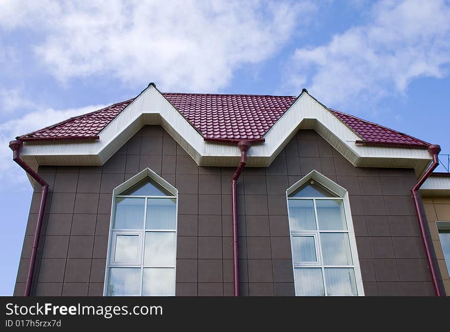 Modern building from a brick. Red tile roof. Modern building from a brick. Red tile roof.