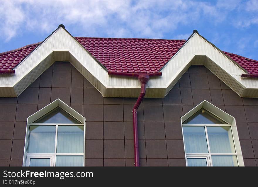 Modern building from a brick. Red roof. A tile. Modern building from a brick. Red roof. A tile.