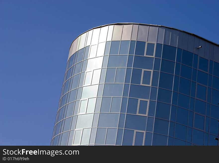 Modern urban building. Glass windows. Modern urban building. Glass windows.