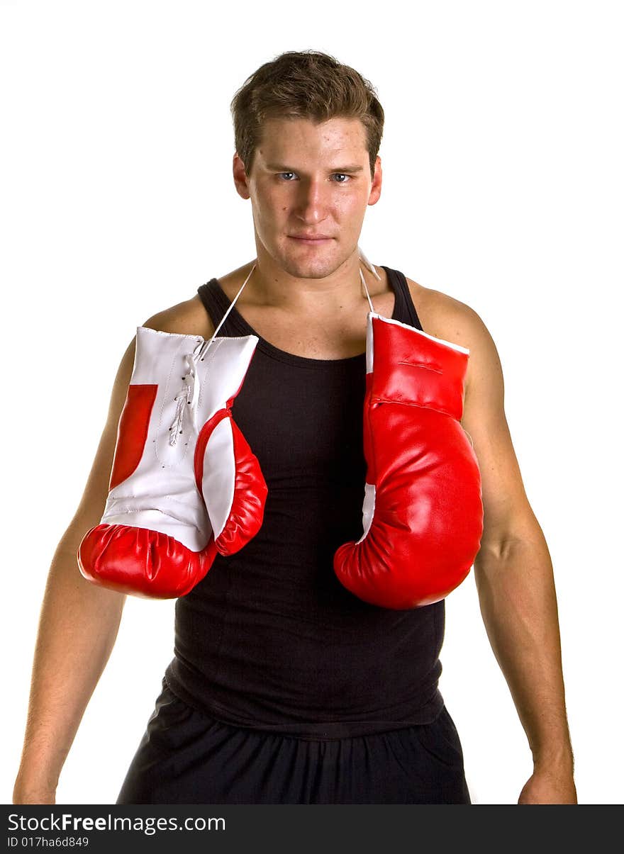 A boxer in workout clothes and red boxing gloves isolated on white. A boxer in workout clothes and red boxing gloves isolated on white