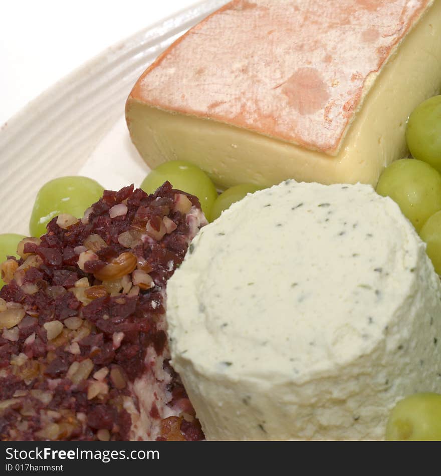 Three different soft cheeses and green grapes. Three different soft cheeses and green grapes