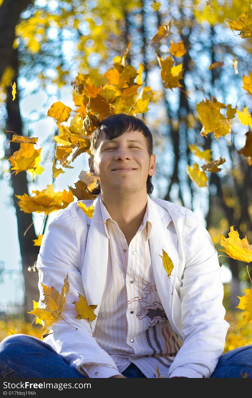 Young man playing with leaves. Young man playing with leaves