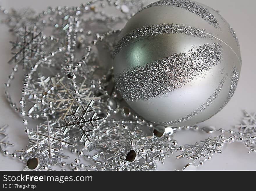 The striped sphere lays on brilliant snowflakes