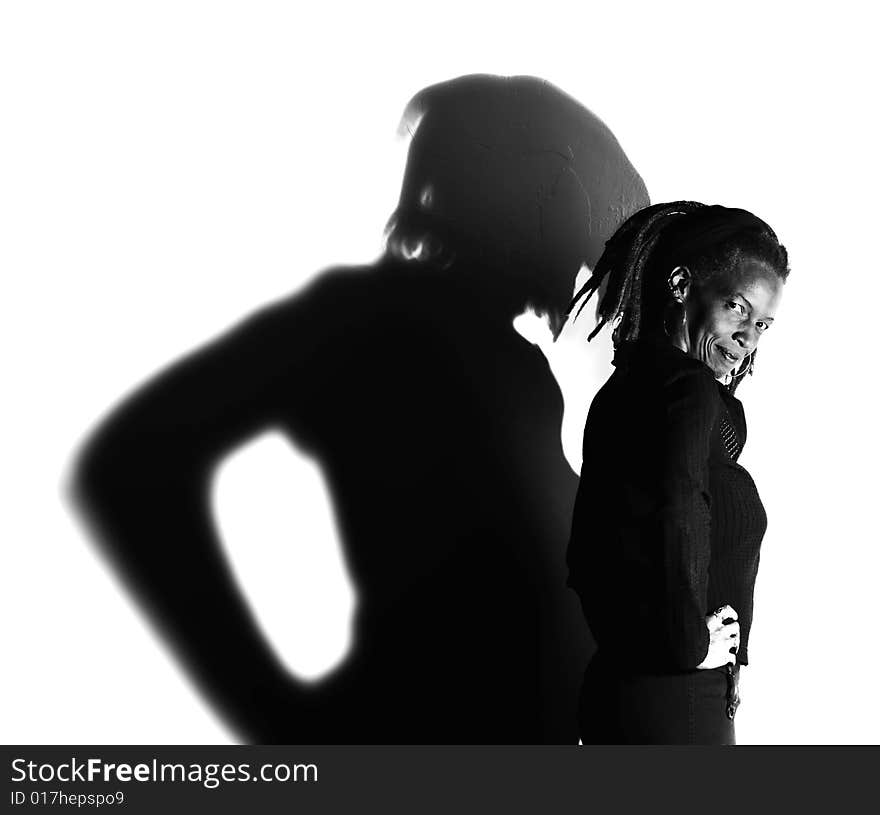 African American woman with dreadlocks against a white wall. African American woman with dreadlocks against a white wall