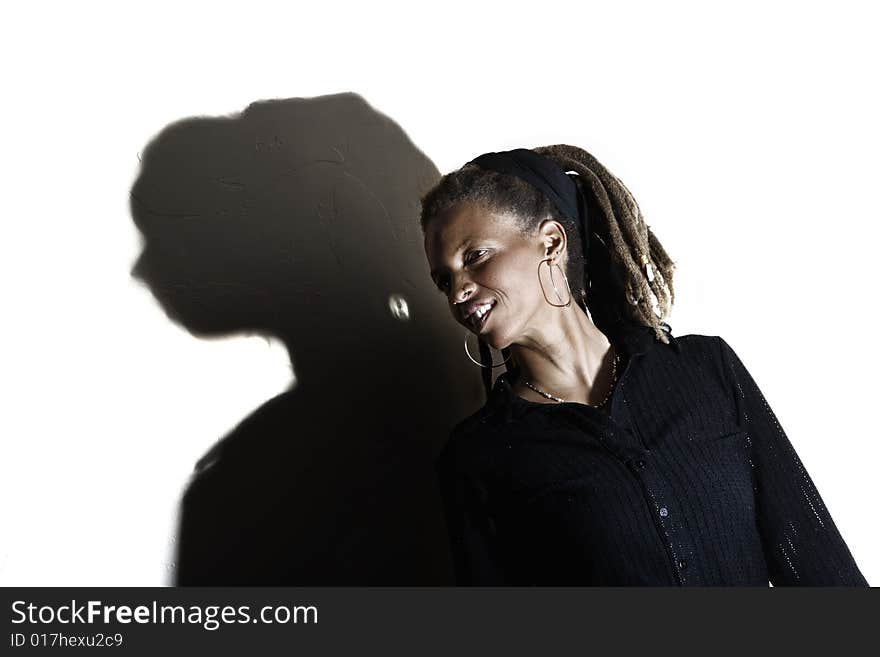 African American woman with dreadlocks against a white wall. African American woman with dreadlocks against a white wall