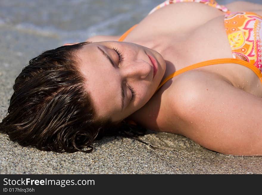 Portrait of a beautiful woman sitting on the beach. Portrait of a beautiful woman sitting on the beach