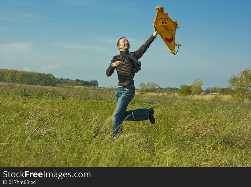 Man feeling free while running and flying a kite. Man feeling free while running and flying a kite