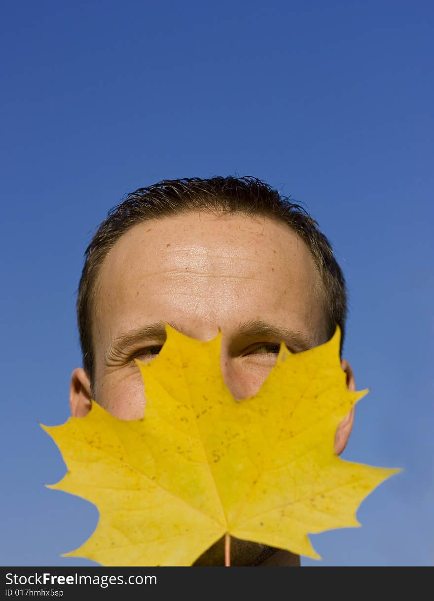 Young man blue sky with leaf. Young man blue sky with leaf