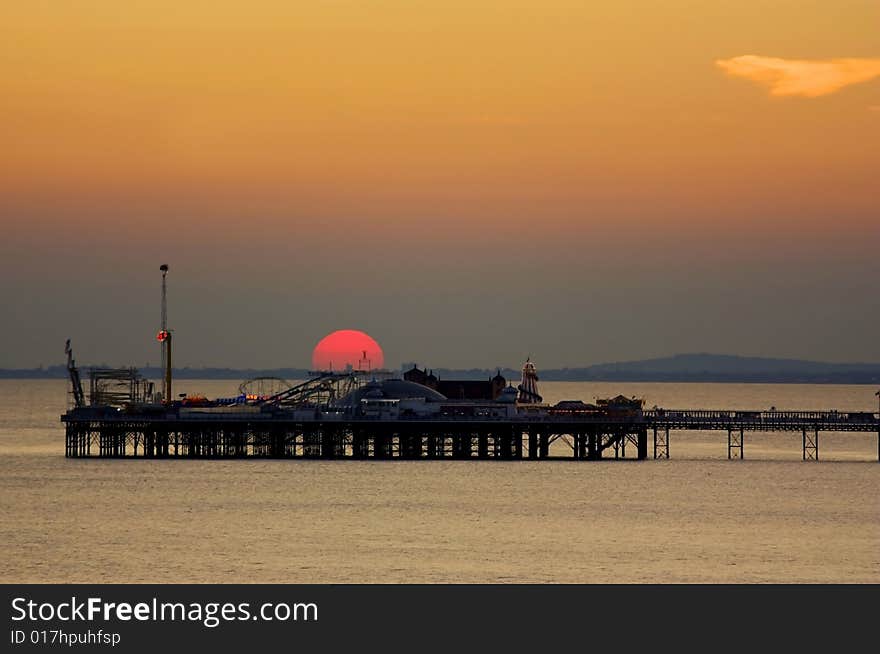Sunset behind the Palace Pier in Brighton, England. Sunset behind the Palace Pier in Brighton, England