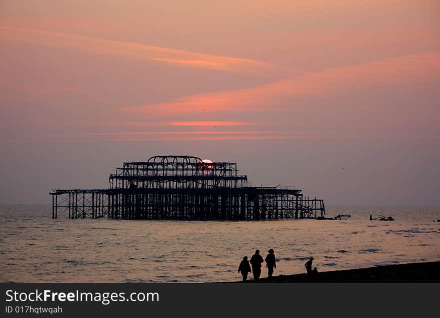 Burnt down West Pier in Brighton, England at sunset