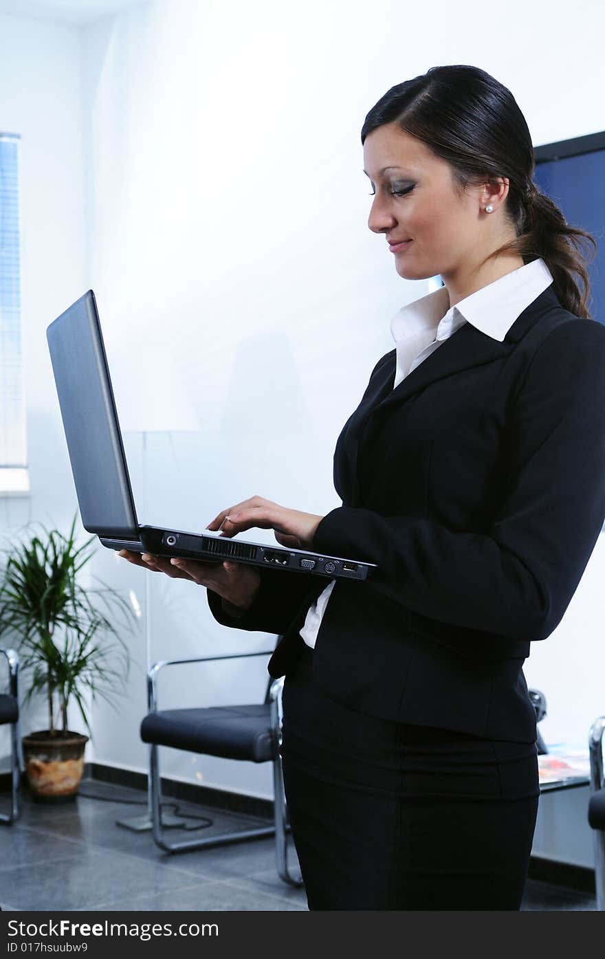 woman in office, to be up and to make use of laptop with wireless technology
. woman in office, to be up and to make use of laptop with wireless technology