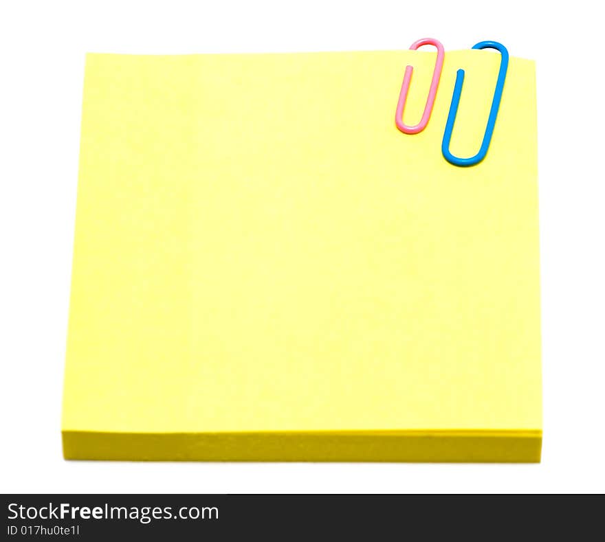 Yellow pages of notebook with paper clip on white