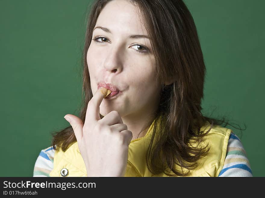 Woman licking peanut butter from her finger. Woman licking peanut butter from her finger