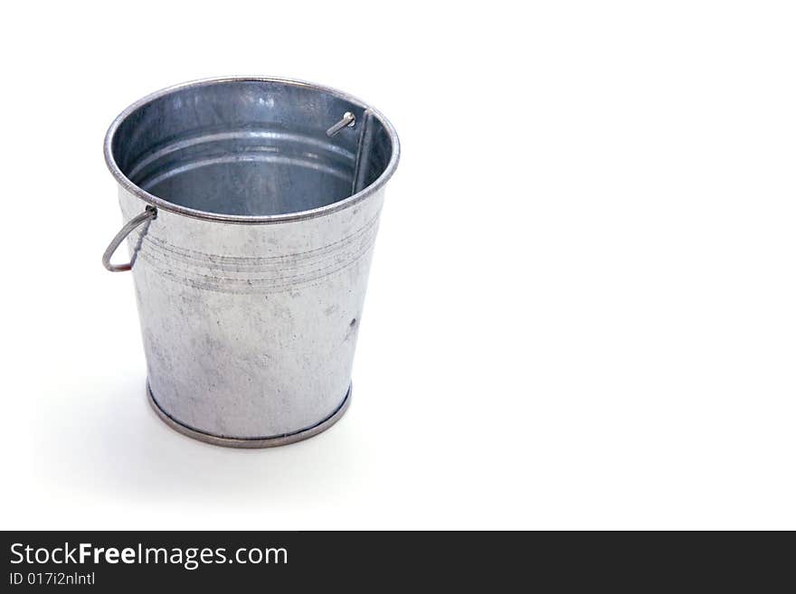 Galvanized metal bucket with shadow on white field. Galvanized metal bucket with shadow on white field