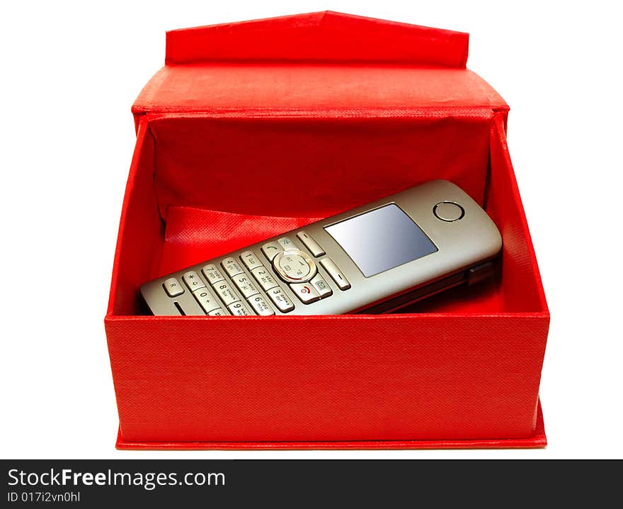 Gray (silver) mobile (radio) telephone and red cardboard box on isolated background. Gray (silver) mobile (radio) telephone and red cardboard box on isolated background.