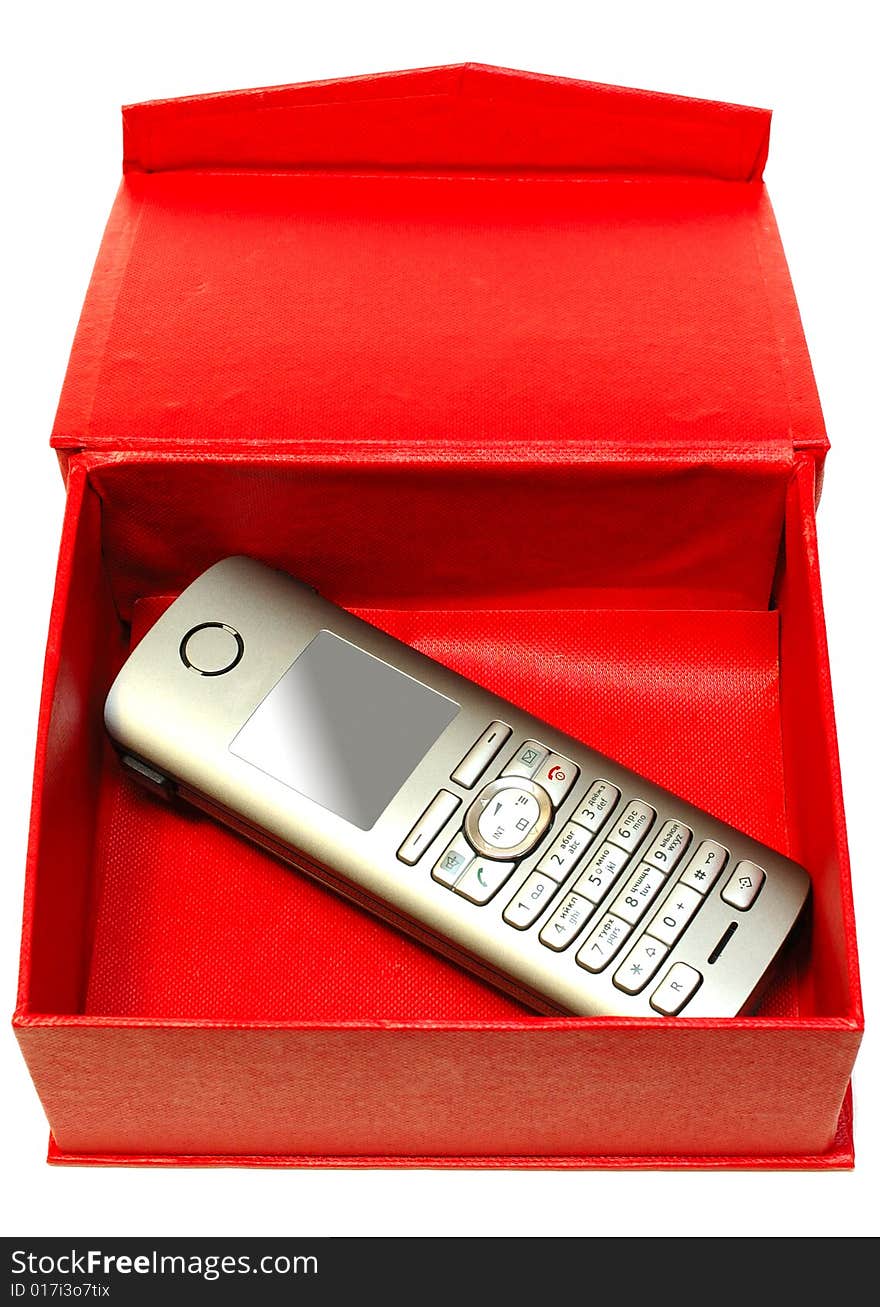 Gray (silver) mobile (radio) telephone and red cardboard box on isolated background. Gray (silver) mobile (radio) telephone and red cardboard box on isolated background.