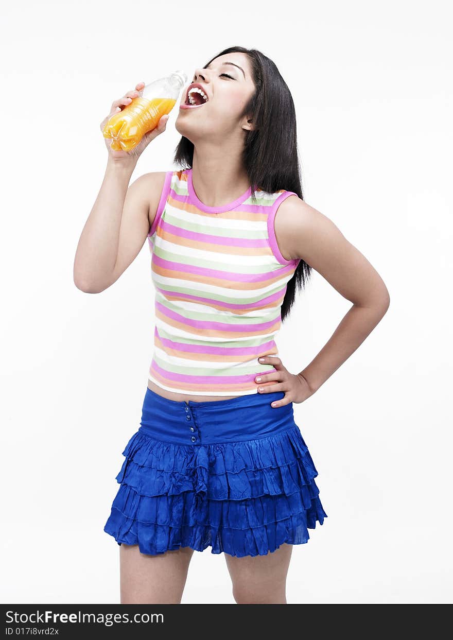 Asian female drinking bottled juice. Asian female drinking bottled juice