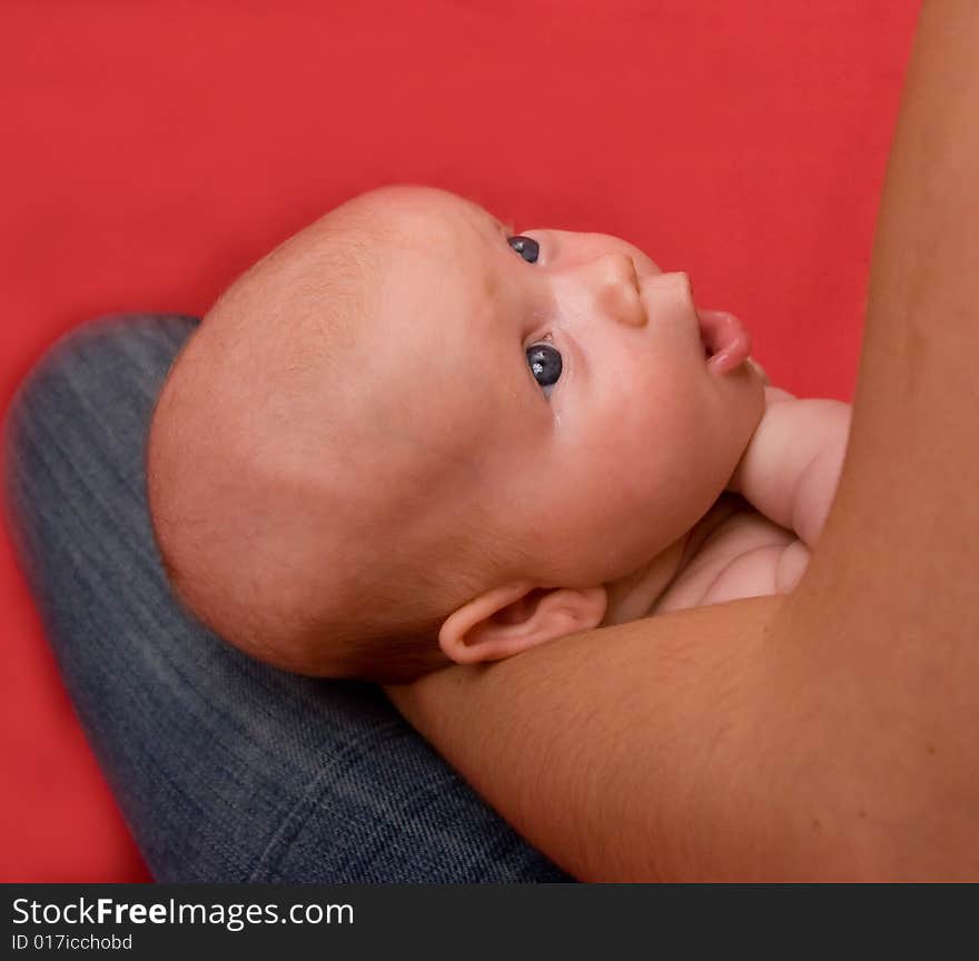 Happy baby with mother over red background. Happy baby with mother over red background