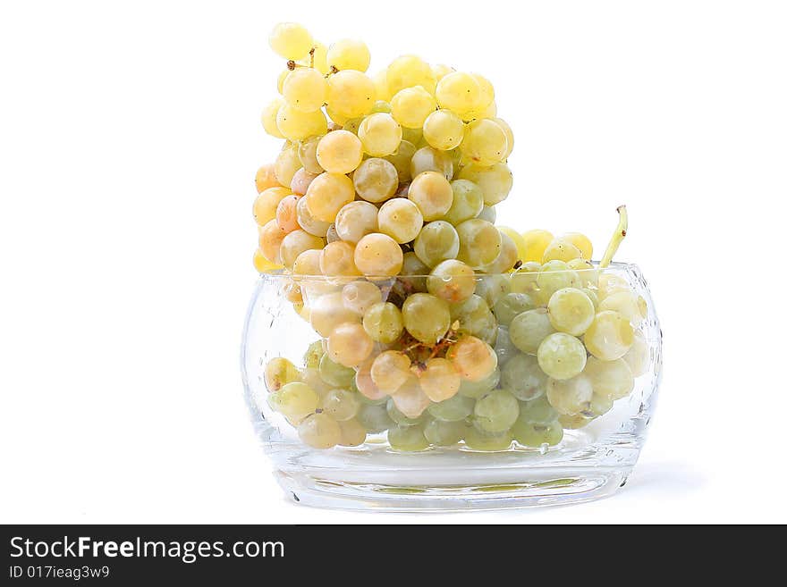 Close-up of grapes in a glass bowl on white background. Close-up of grapes in a glass bowl on white background