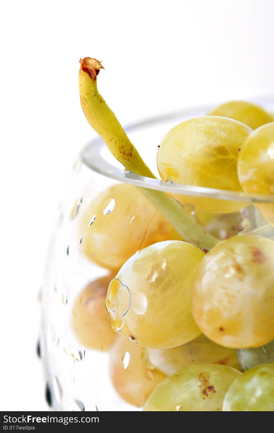 Close-up of grapes in a glass bowl on white background. Close-up of grapes in a glass bowl on white background