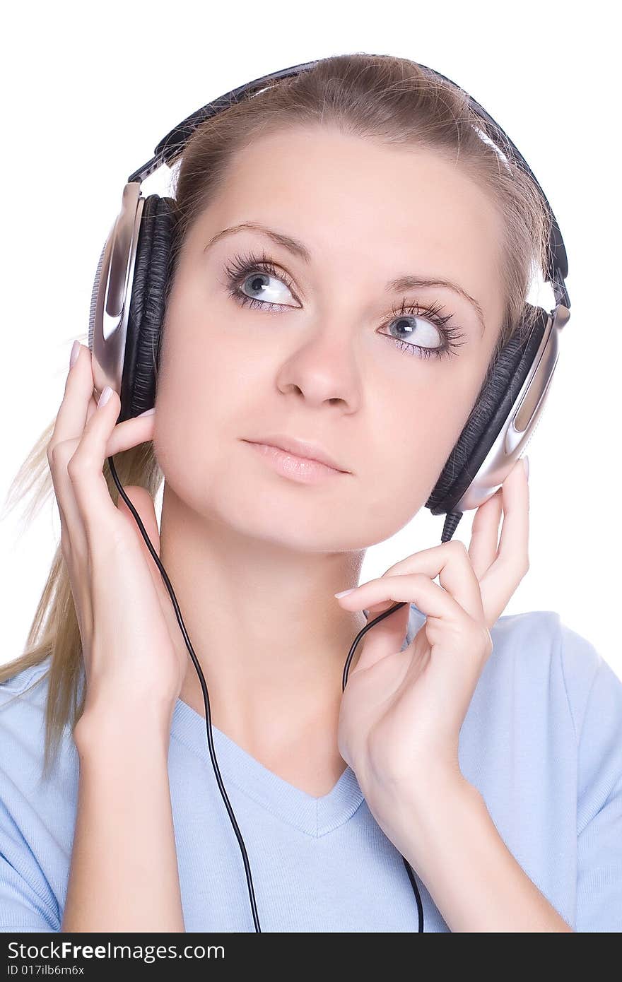 Isolated smiling young girl listening to music. Isolated smiling young girl listening to music