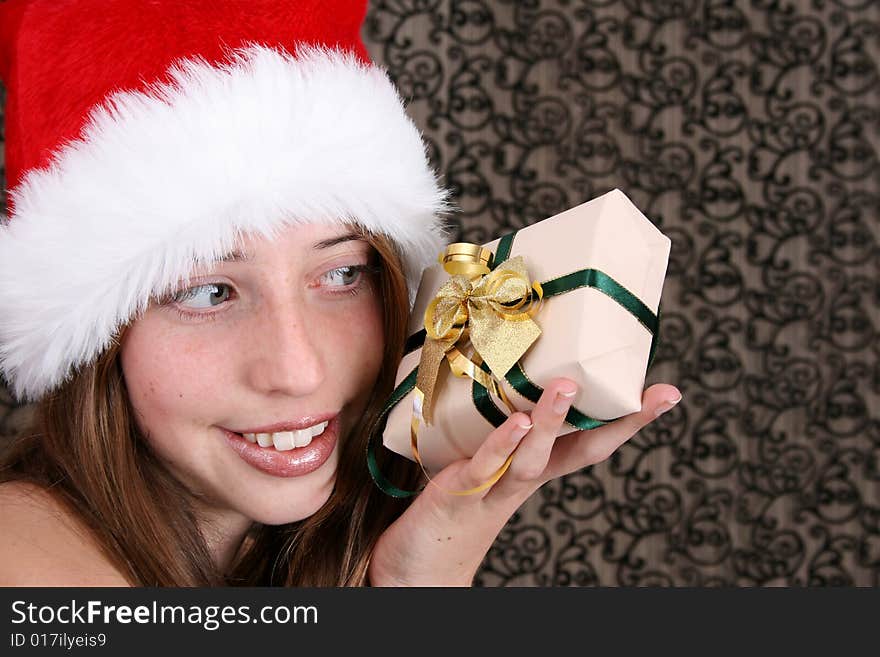 Brunette Teenager wearing a fluffy christmas hat. Brunette Teenager wearing a fluffy christmas hat