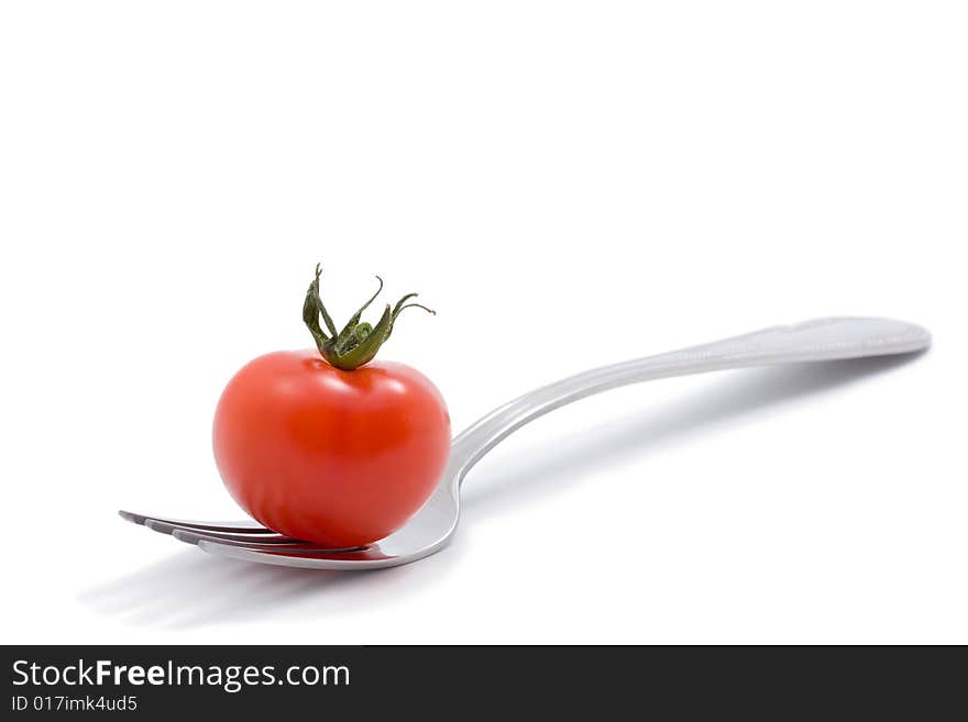 Red Tomato On A Fork Isolated