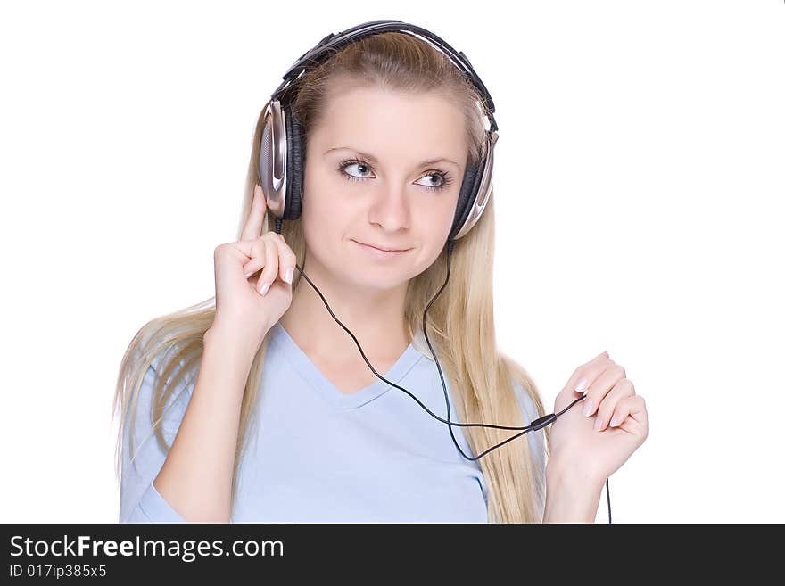 Isolated smiling young girl listening to music. Isolated smiling young girl listening to music