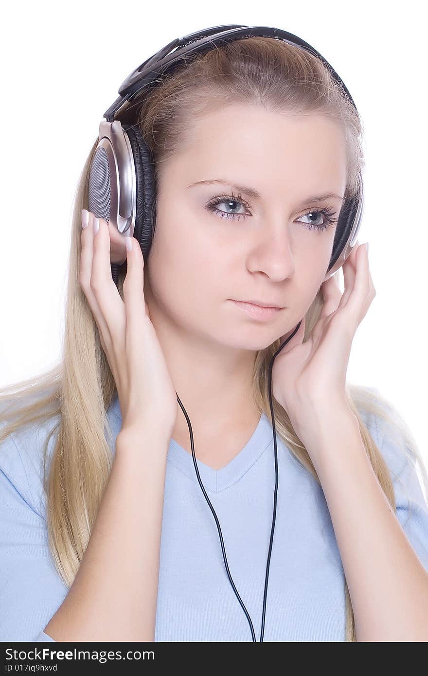 Isolated smiling young girl listening to music. Isolated smiling young girl listening to music