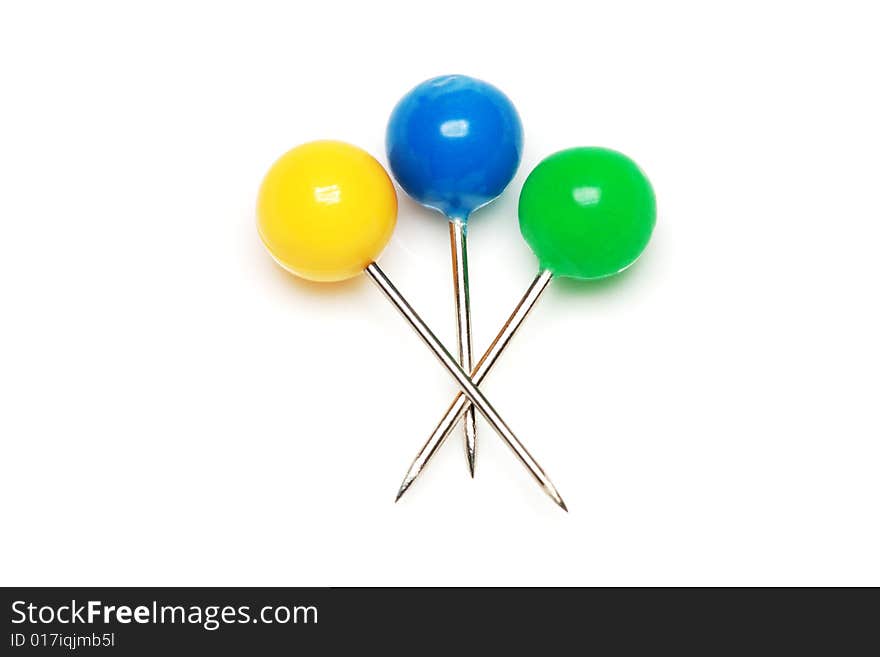 Yellow, blue and green push pins isolated on white background.