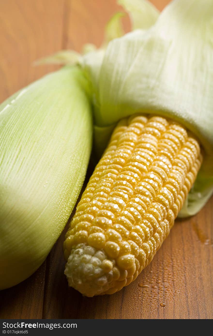 Fresh maize with water droplets on a table