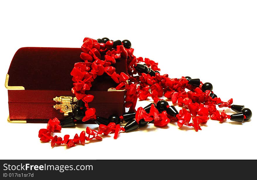 Bright coral red and black beads (necklace) and crimson velvet box for jewelry (jewellery) on isolated background. Bright coral red and black beads (necklace) and crimson velvet box for jewelry (jewellery) on isolated background.