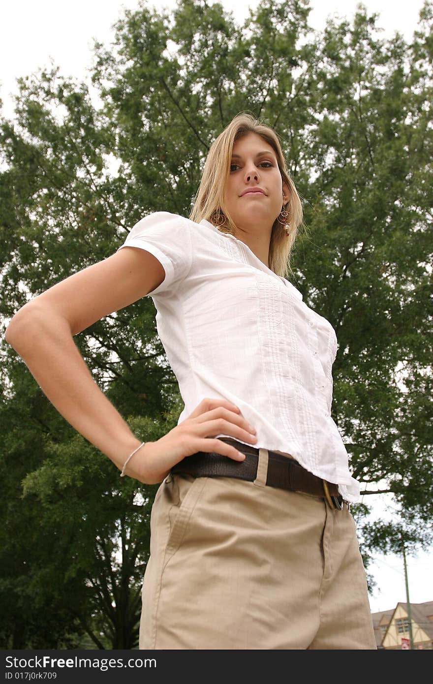 Young woman posing outside wearing a white top