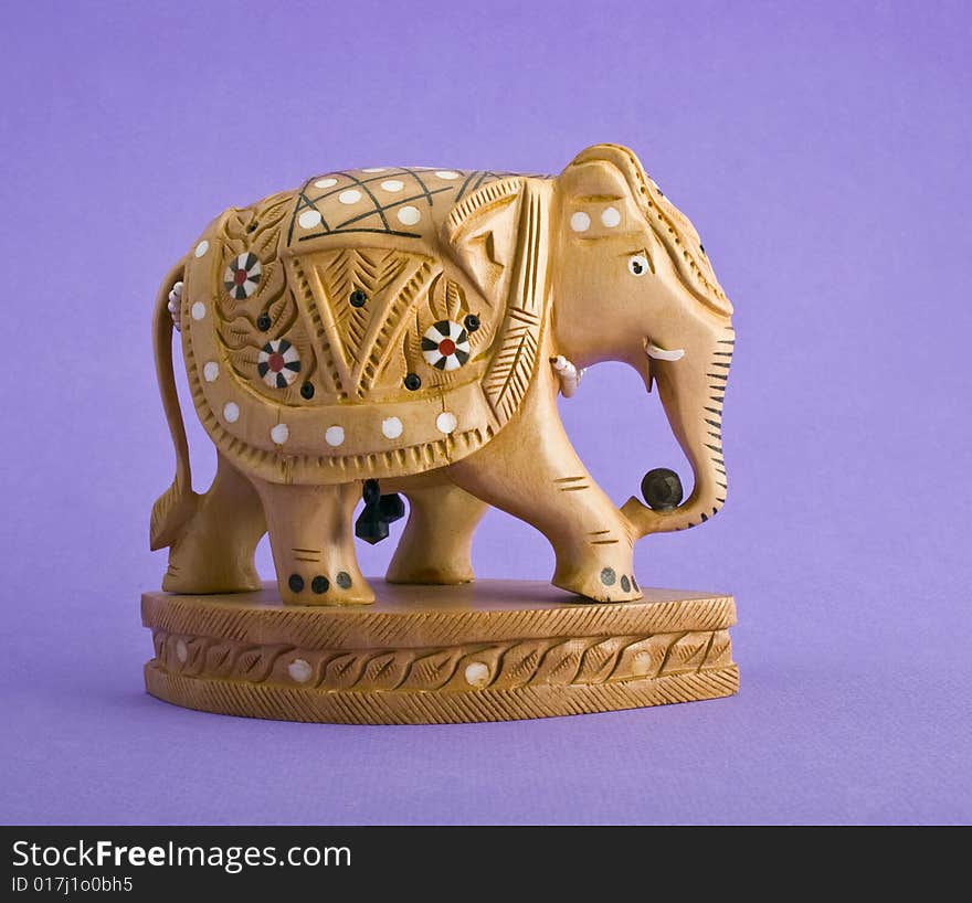 Elephant figurine close-up isolated on violet background