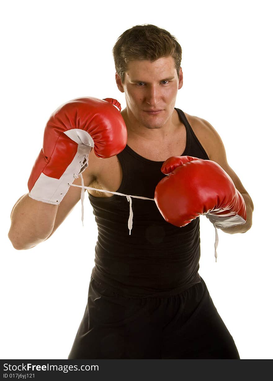 A boxer in workout clothes and red boxing gloves isolated on white. A boxer in workout clothes and red boxing gloves isolated on white