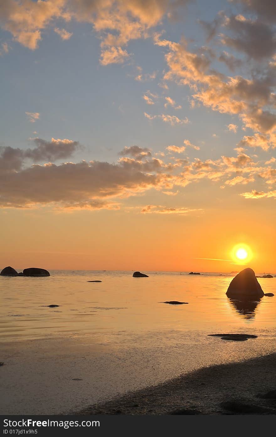 Orange sunset above stones