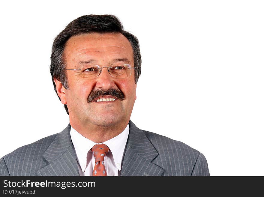 A businessman in his sixties with glasses a suit and a mustache. Isolated over white. A businessman in his sixties with glasses a suit and a mustache. Isolated over white.