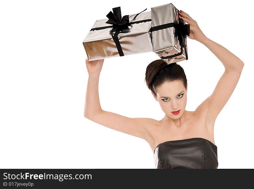 Young woman holding Christmas gifts above her head isolated on white background