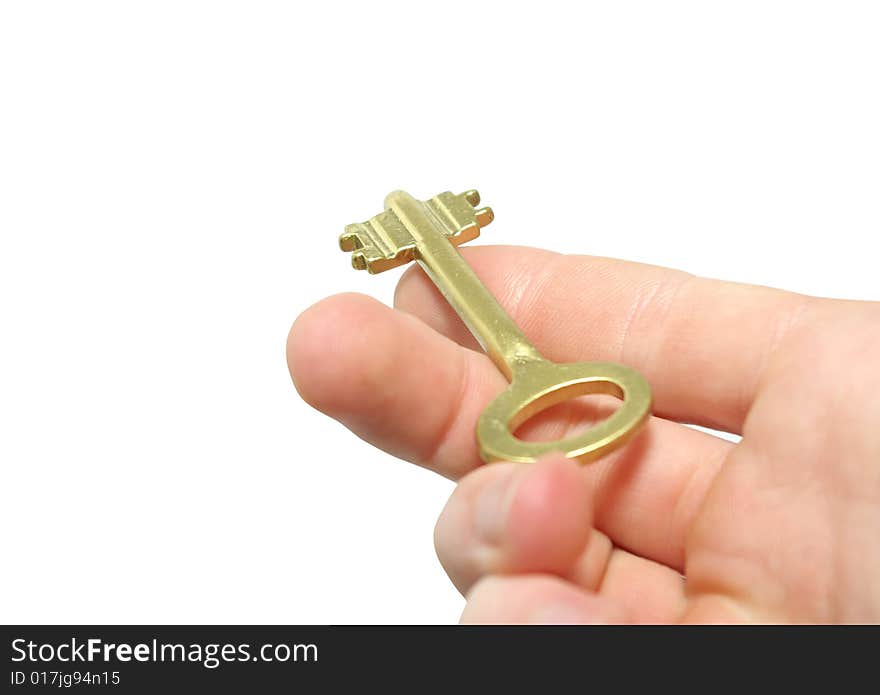 Fingers holding golden keys isolated on white